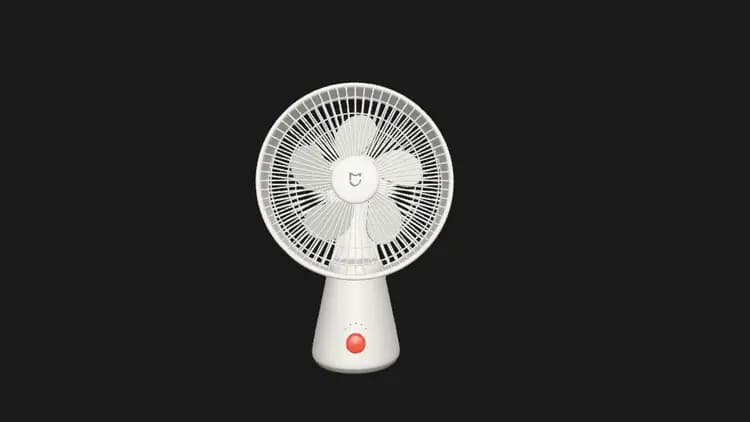 White desktop fan with a rounded cage, five blades, an orange speed button and indicator lights.